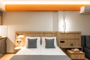 a bedroom with a large white bed with pillows at Nerium Apartments Leptokaria in Leptokarya +65 photos