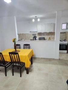a dining room with a yellow table and chairs at Apartment Tamara in Tivat