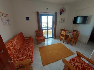 A television and/or entertainment centre at Anglo Chalets - Ageeba beach