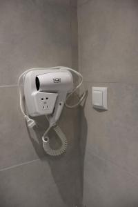 a hair dryer on a wall in a bathroom at Gyumri House Kentron in Gyumri