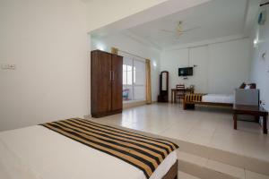 Postel nebo postele na pokoji v ubytování Hotel Oviya