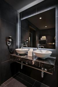 two sinks on a counter in a black bathroom at Verdi Gzira Promenade in Sliema +43 photos