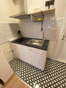 a small kitchen with a sink and a tiled floor at Sapphire Suites Taksim in Istanbul +99 photos