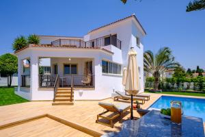 a villa with a swimming pool and a house at Harmonia Luxury Villa by Nomads in Peyia