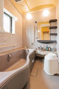 a bathroom with a large tub and a sink at 彦宿Hikojyuku戸建て貸切宿 in Hikone +29 photos
