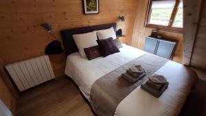 a bedroom with a large bed in a log cabin at Valley Lodge in La Bresse