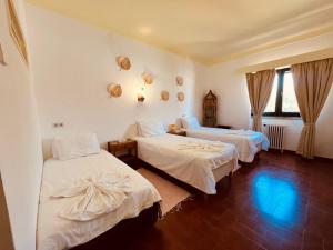 a room with two beds with white sheets at Casa Santo António in São Brás de Alportel +40 photos