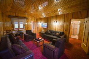 a living room with two couches and a table at Lahza Hills Resort in Çaykara