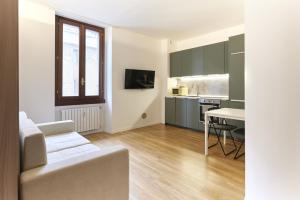 un soggiorno con un divano bianco e una cucina di Nolo studio walking distance from Loreto e Corso Buenos Aires a Milano