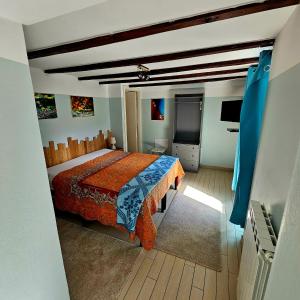 a bedroom with a bed and a television in it at Borgo Paradiso Guest House in Maccagno Inferiore