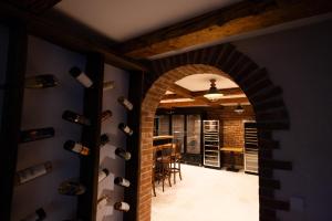an archway in a room with wine bottles at Pensiunea La Vâltoare in Sibiu
