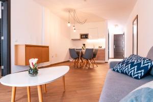 a living room with a couch and a table at Los Cardones Boutique Village in Playa de las Americas