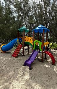 a group of playground equipment in the sand at Villa del Mar Praia Hotel in Camocim