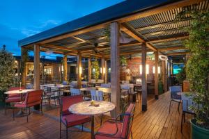 a restaurant with tables and chairs on a deck at BLESS Madrid - The Leading Hotels of the World in Madrid +102 photos