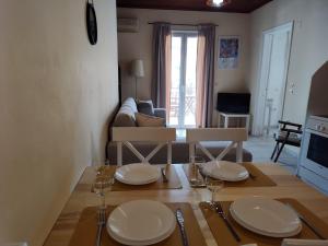 a living room with a table with plates and glasses on it at Evi's house in Nikiana