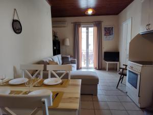 a living room with a couch and a table at Evi's house in Nikiana
