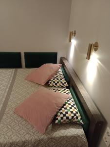 two beds with pillows on them in a room at Alte Brennerei Apartments in Traben-Trarbach