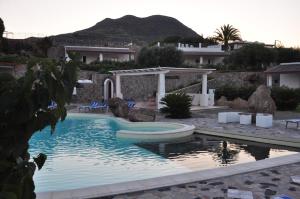 a swimming pool with a slide in a house at Case Vacanze Margherita in Lipari