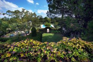 a garden with a pond in the middle at Tenuta Sant'Andrea in Muro Leccese