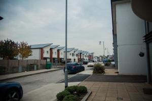 a street with cars parked on the street at Athletes Way House in Manchester