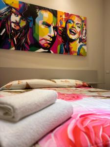 a bedroom with a bed with a painting on the wall at BB Centro Citta in Crotone +24 photos