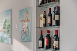 a bunch of bottles of wine sitting on shelves at Hotel Baia Del Capitano in Cefalù