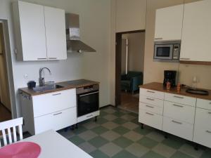 a kitchen with white cabinets and a sink at Linnantie 2 in Mikkeli