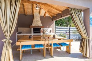 a dining room with a wooden table and chairs at Five bedroom villa Emily with pool in Medulin in Medulin