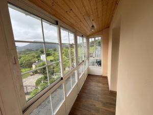 an empty hallway with large windows in a house at La casa del valle in Viveiro