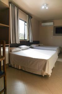 Postel nebo postele na pokoji v ubytování Hotel Villa Canoas