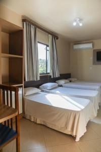 Postel nebo postele na pokoji v ubytování Hotel Villa Canoas