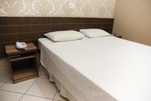 Postel nebo postele na pokoji v ubytování Hotel Villa Canoas