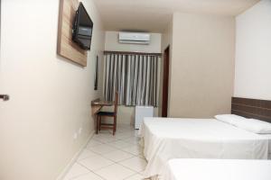 Postel nebo postele na pokoji v ubytování Hotel Villa Canoas