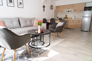 a living room with a couch and a table with chairs at Apartment ANGIE in Mirkovići