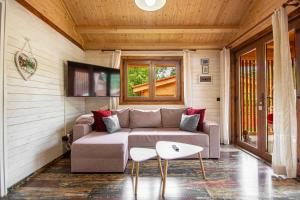 a living room with a couch and a table at Cabanele Sașilor in Cisnădioara
