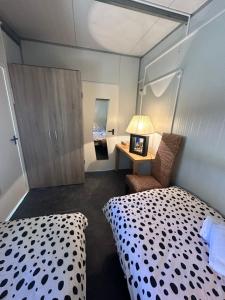 a small bedroom with a bed and a chair at Bungalow GOLOSINA in Torrelaguna +51 photos