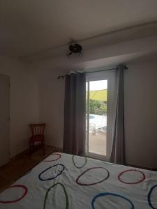 a bedroom with a bed with a view of a patio at T2 piscine proche plage in Carqueiranne