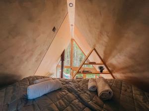 a bedroom with a bed with towels on it at Unique Tiny House in Countryside in Külaaseme