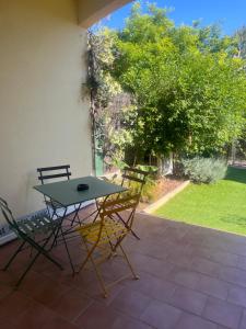 a table and chairs sitting on a patio at Chez Jaggy in Carqueiranne +3 photos