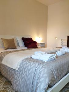 a bedroom with a large bed with towels on it at Petalo Rosso b&b in Lenola