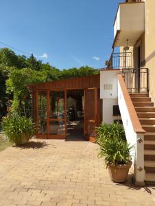 a building with glass doors and potted plants at Petalo Rosso b&b in Lenola