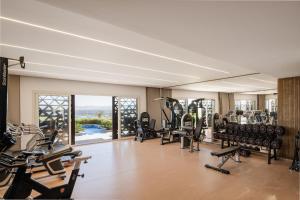 a gym with a lot of treadmills and ellipticals at The Zen Wellness Resort in Aswan
