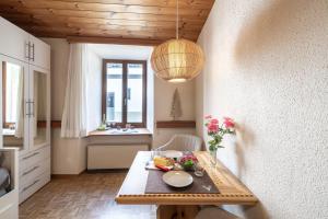 a dining room with a table with food on it at Chasa Vi Studio in Scuol