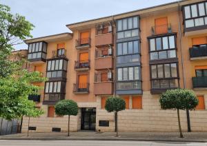 an apartment building with trees in front of it at EL RINCÓN DE SAN NICOLÁS in Soria