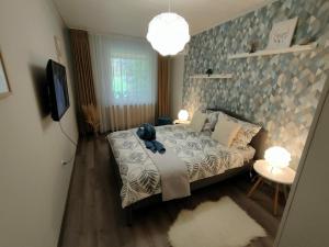 Postel nebo postele na pokoji v ubytování Silver Lake Apartman
