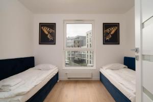 Posteľ alebo postele v izbe v ubytovaní Przystań Letnica by Comfort Apartments