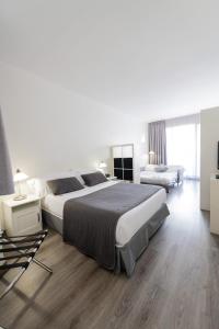 Posteľ alebo postele v izbe v ubytovaní Aparthotel Atenea Calabria