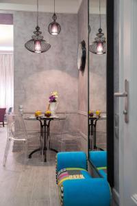 a dining room with blue chairs and a table at Boutique Apartment in Budapest