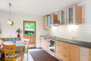 a kitchen with a table and a dining room at Appartment Stockeben in Niederau