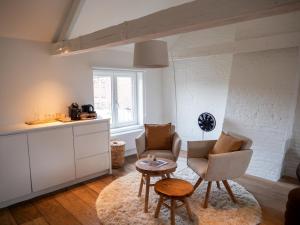 a living room with two chairs and a table at B&B Residence9Bruges in Bruges